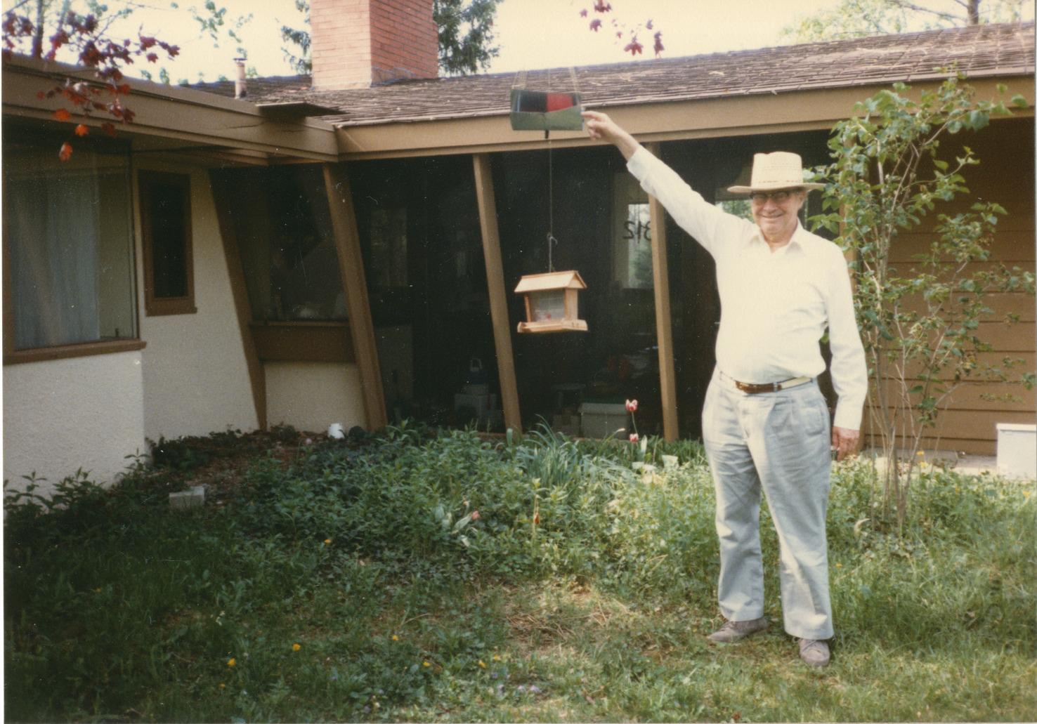 Person Standing at Bird Feeder in front of 312 E. South Street