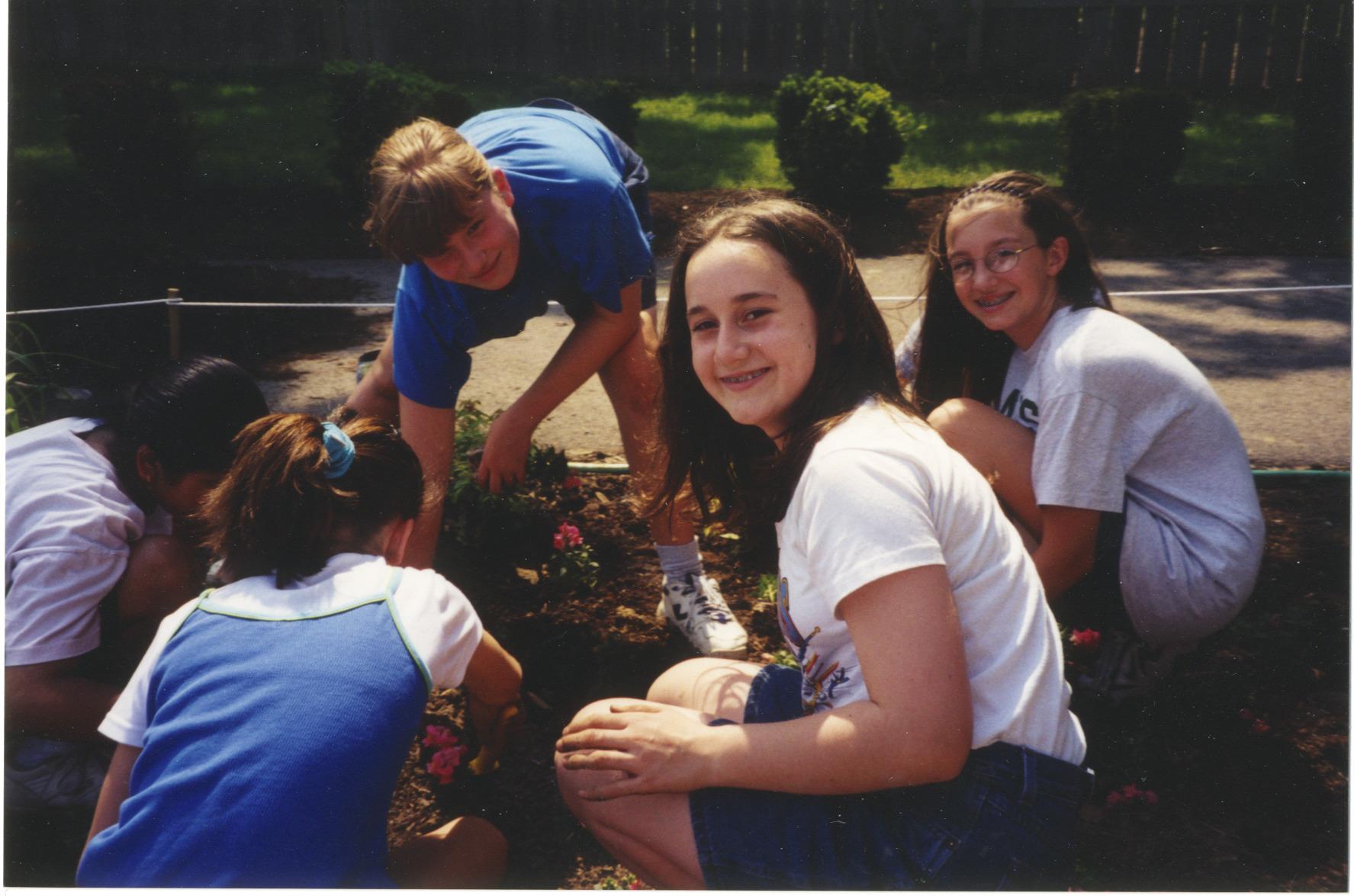Photograph of Children Smiling While Planting the Storybook Garden at Northwest Library
