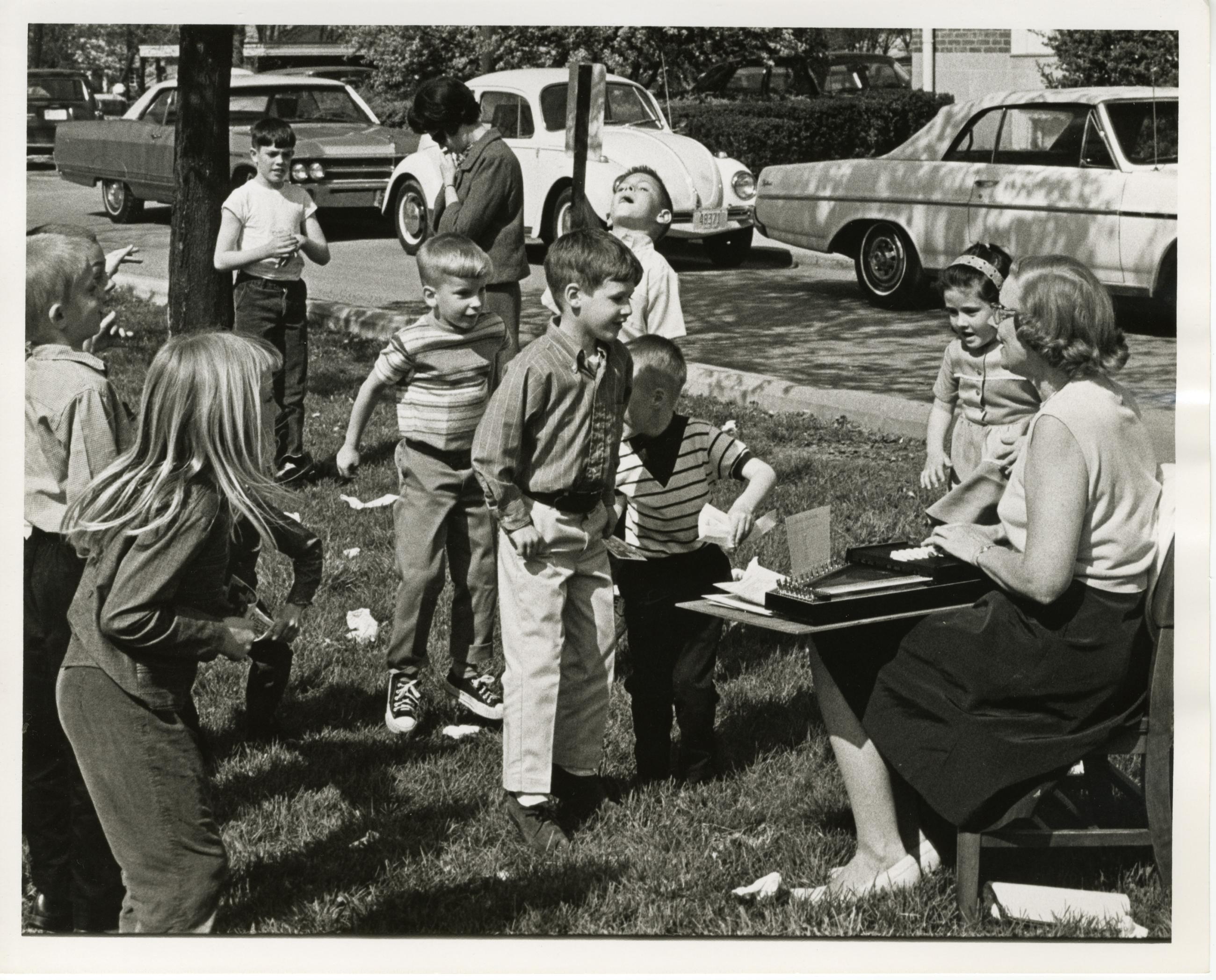 Photograph of Children and Adult with Autoharp Outside at the Worthington Public Library's National Library Week Celebration, 1968
