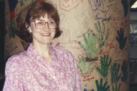 Photograph of Jo Osborne with "Red Hot Readers" Pillar