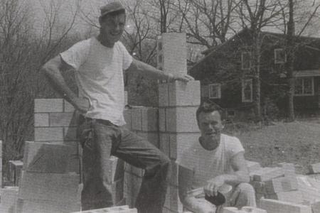 Two People Standing with Foundation Blocks for 290 E. South Street